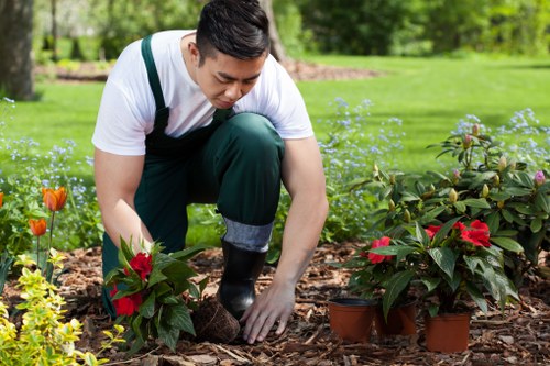 Team member handling garden waste safely during routine maintenance